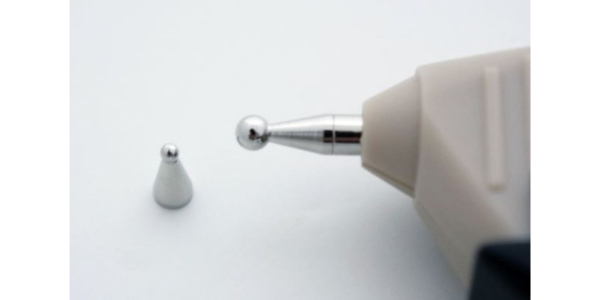 A close up of an electric toothbrush on top of a table.